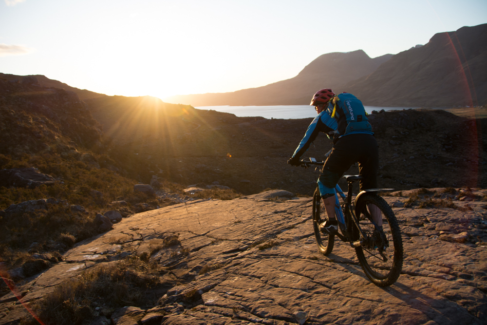 Ciclista de montaña al atardecer en las Highlands de Escocia